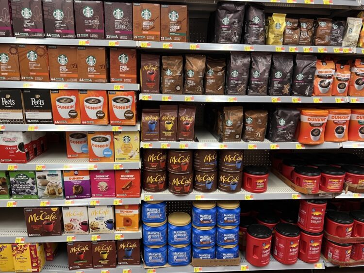 selection of cheap coffee brands on the supermarket shelf like dunkin, mcdonalds, folgers, maxwell house and maxwell house