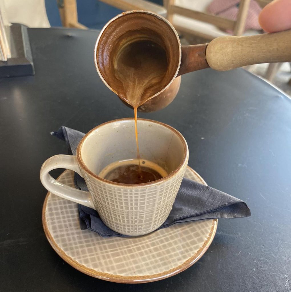 Traditional Greek coffee poured from a briki / tzisves (Ibrik)