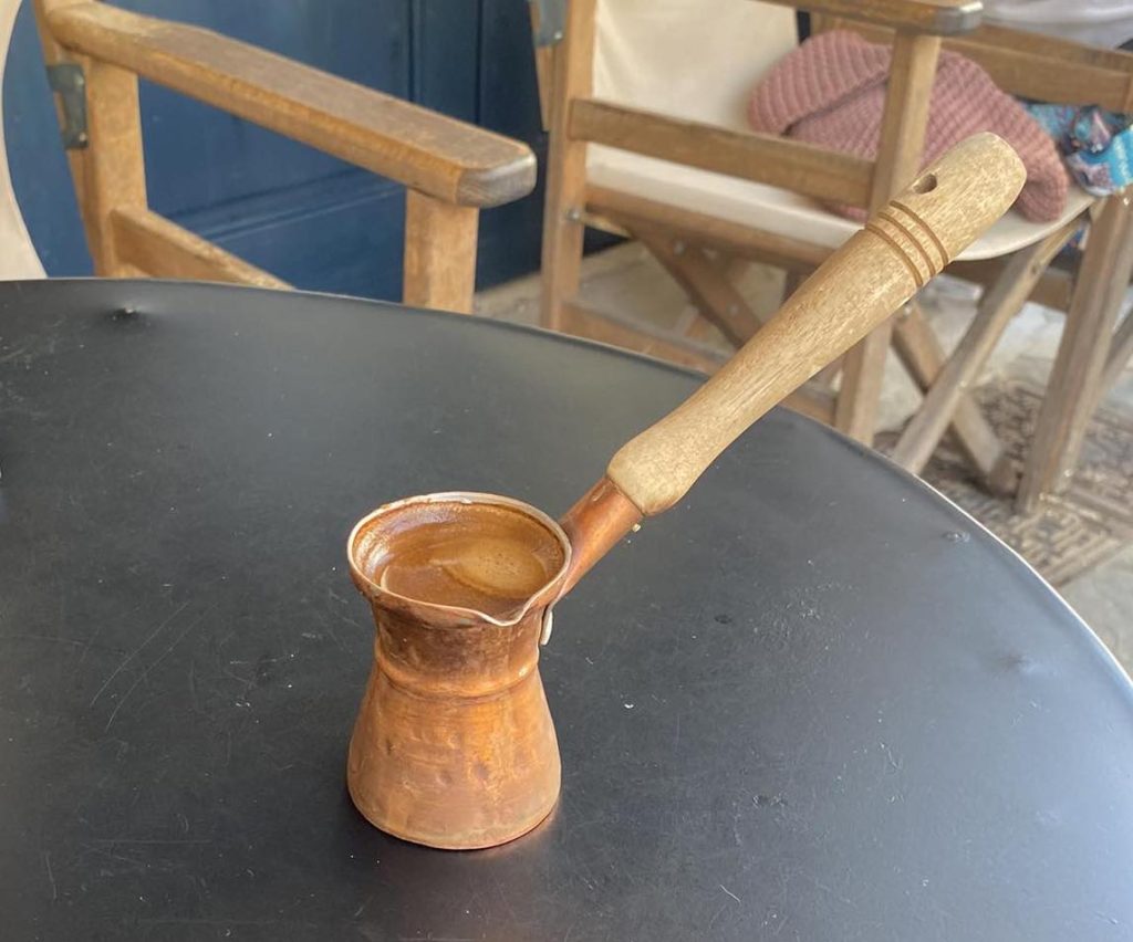 Traditional Greek coffee in a briki / tzisves (Ibrik)
