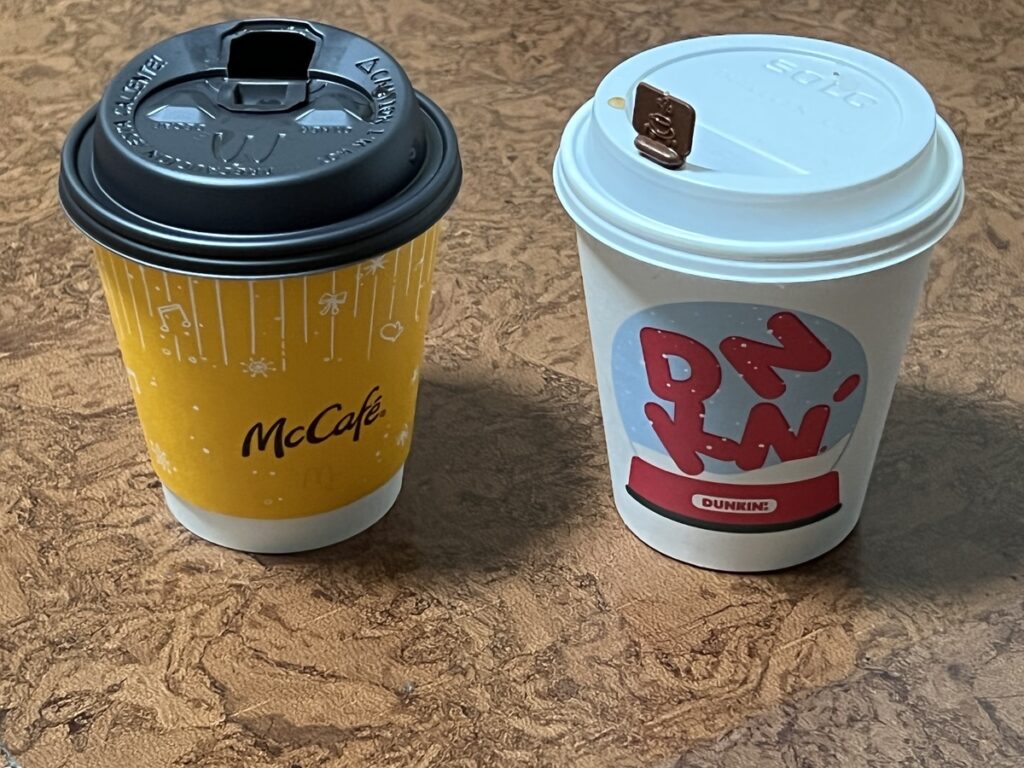mcdonalds and dunkin coffee cups side by side
