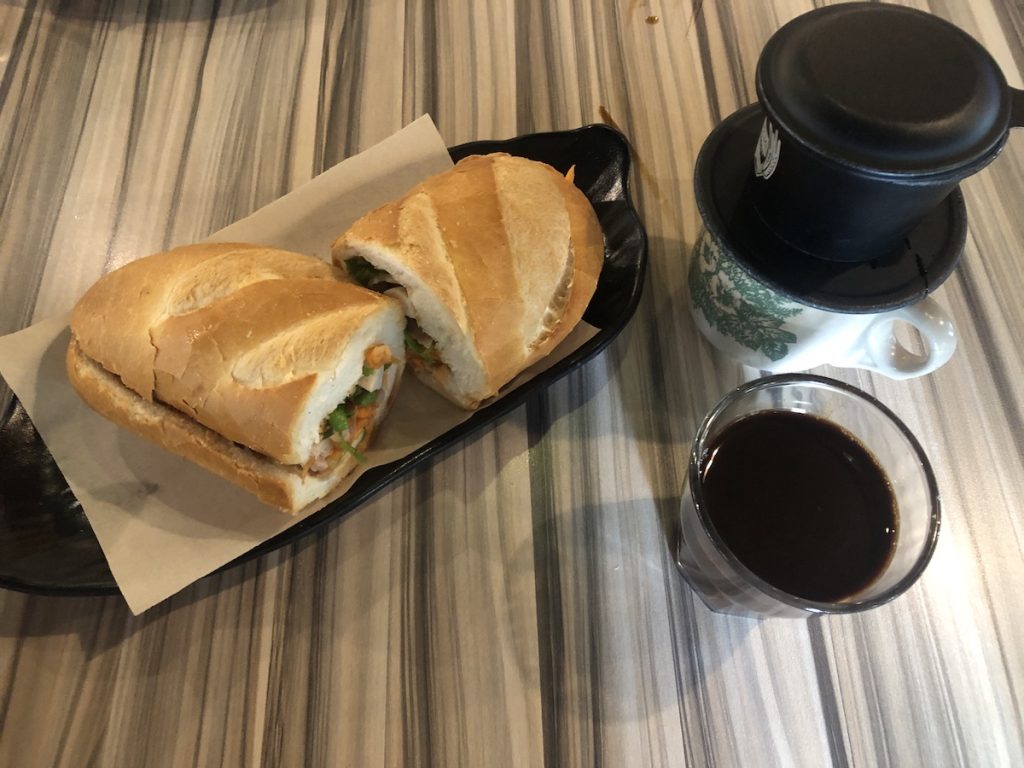 Vietnamese drip coffee and a bahn mi sandwich